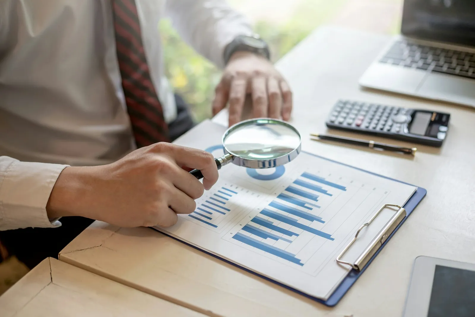 A magnifying glass over a business document