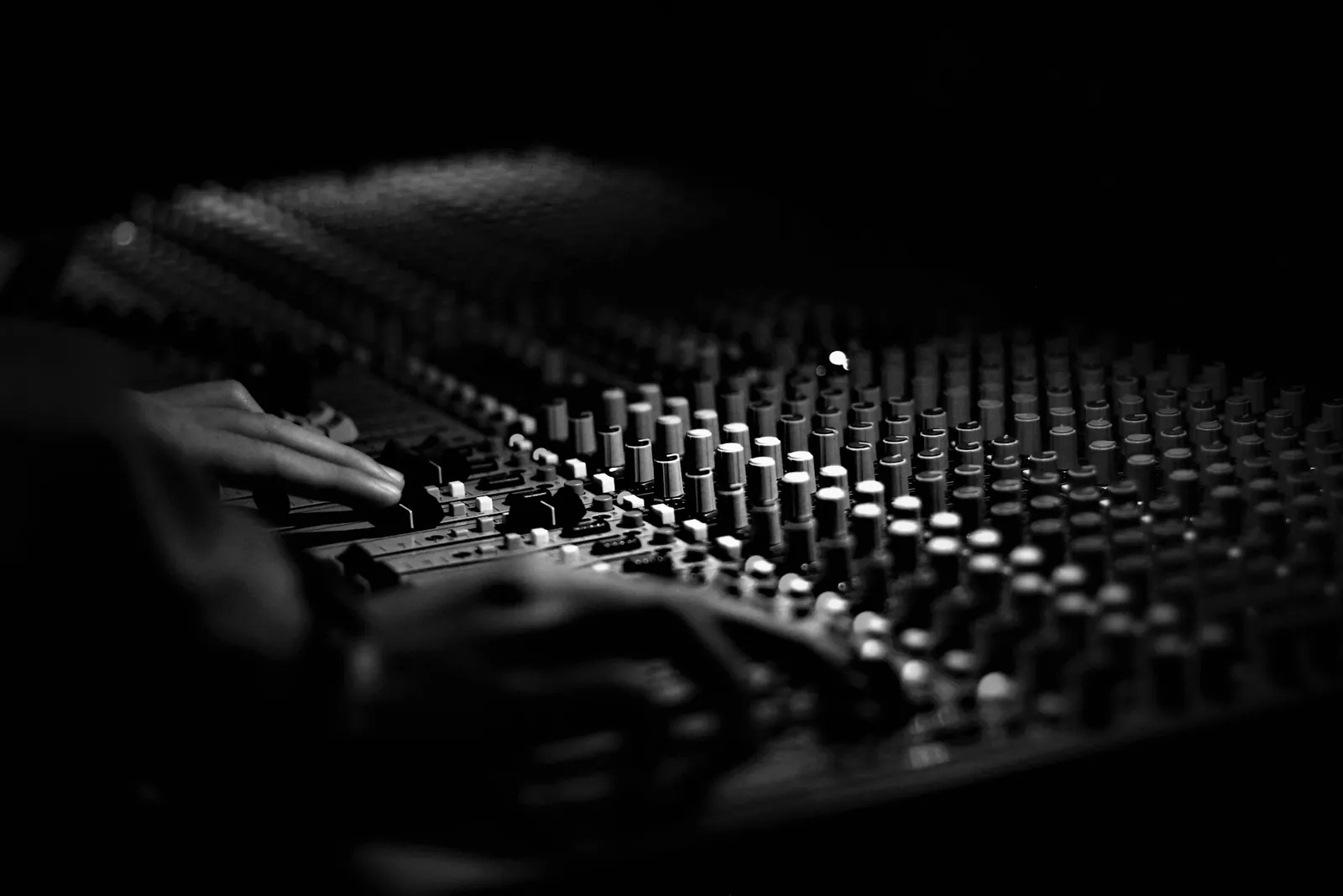 The faders of an audio mixing console
