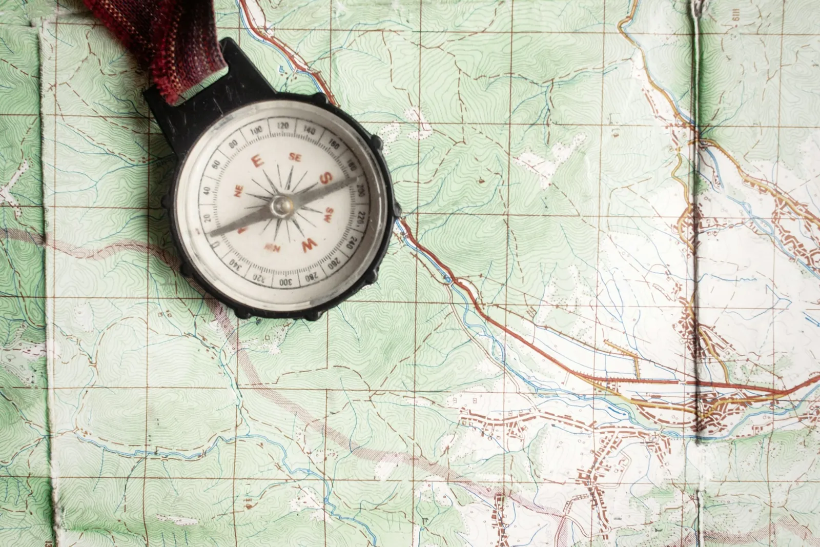 A compass resting on a topographic map